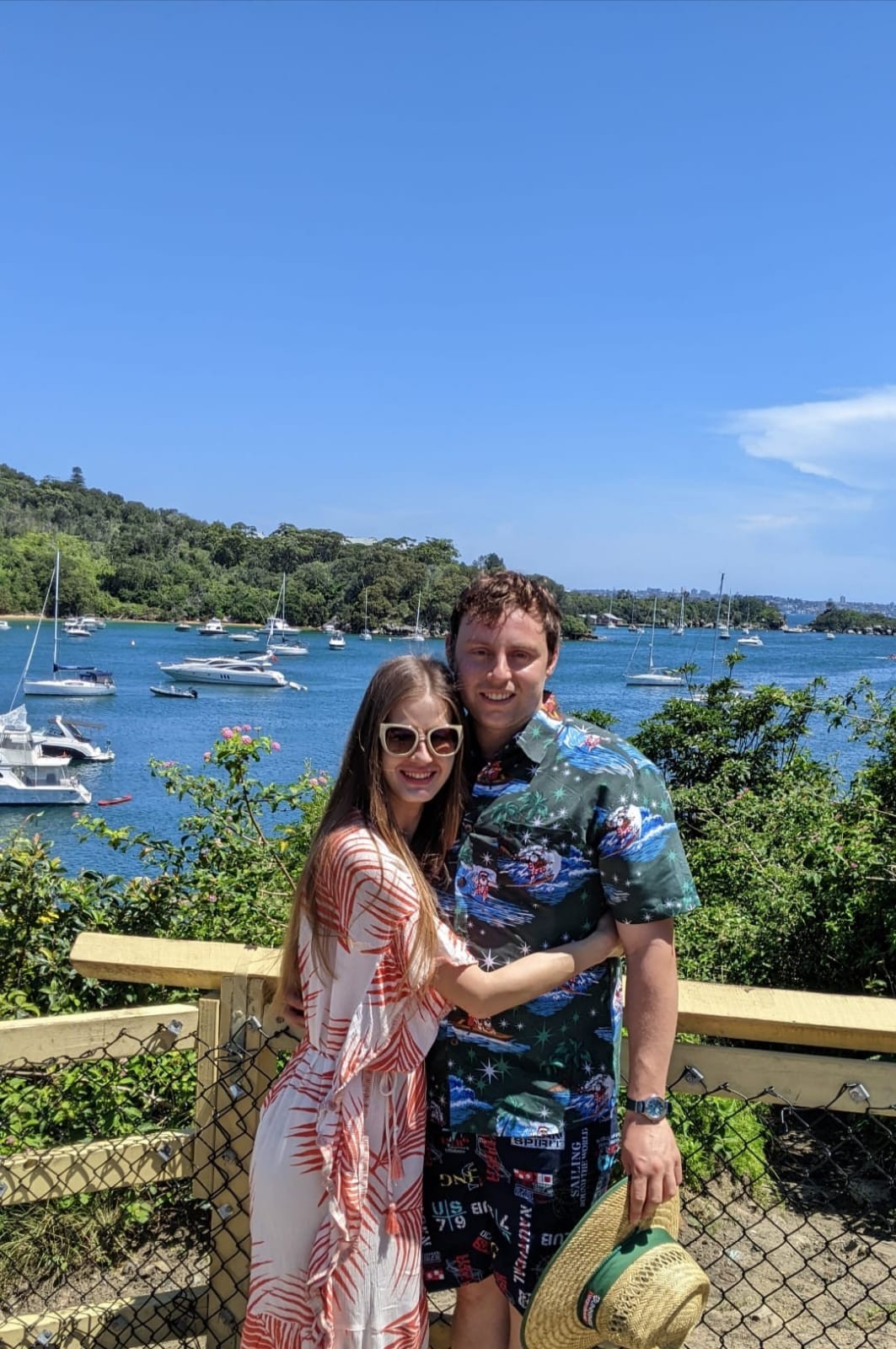 Elena and Louis standing above a harbour full of sailboats