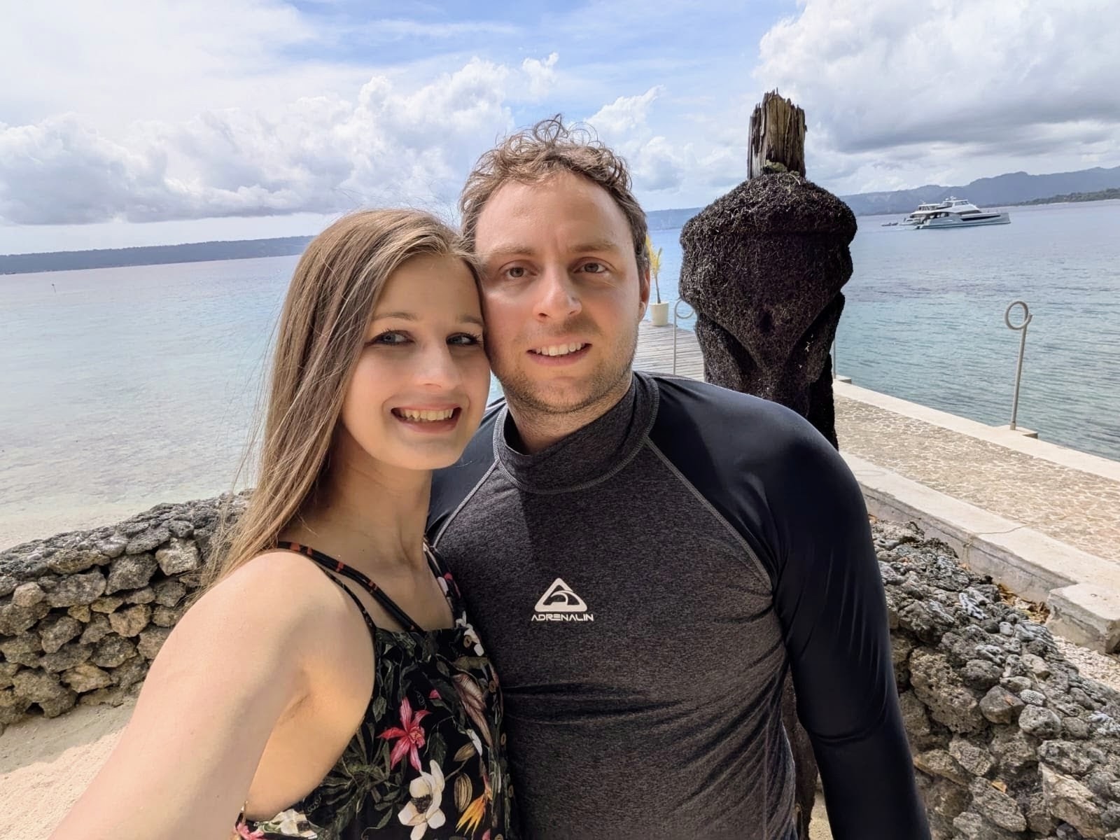Elena and Louis on a shoreline in the tropics